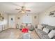 Well-lit living room with tile floors, a decorative front door, and a comfortable seating area at 1635 W Grovers Ave, Phoenix, AZ 85023