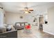 Bright living room with tile floors, ceiling fan, neutral walls, and a glimpse into the dining area at 1635 W Grovers Ave, Phoenix, AZ 85023