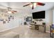 Open-concept living room featuring tile floors, ceiling fans, and a wall-mounted television at 1635 W Grovers Ave, Phoenix, AZ 85023