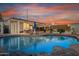 Outdoor living enhanced by ambient lighting illuminates the covered patio and relaxing pool area at 1635 W Grovers Ave, Phoenix, AZ 85023