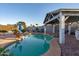 Backyard pool with a shaded gazebo and a peaceful rock waterfall feature, ideal for relaxation at 1635 W Grovers Ave, Phoenix, AZ 85023