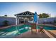 Inviting pool area with a covered outdoor kitchen, mature landscaping, and ample space for entertaining at 1635 W Grovers Ave, Phoenix, AZ 85023