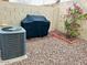 Relaxing backyard featuring a grill, plants, and a air conditioning unit offering a comfortable outdoor living space at 1750 W Union Hills Dr # 91, Phoenix, AZ 85027