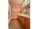 Bathroom featuring a double vanity, tile flooring, a shower/tub combination, and a window at 1750 W Union Hills Dr # 91, Phoenix, AZ 85027