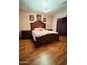 Bedroom featuring a hardwood floor, a large bed, and decorative wall art at 1750 W Union Hills Dr # 91, Phoenix, AZ 85027