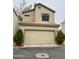 Inviting two-story home with a neutral color palette, red tile roof, and manicured greenery enhancing curb appeal at 1750 W Union Hills Dr # 91, Phoenix, AZ 85027