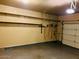 Clean garage with epoxy flooring, overhead shelving, and storage for tools at 1750 W Union Hills Dr # 91, Phoenix, AZ 85027