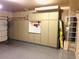 Well-organized garage with ample storage cabinets, pegboard, and epoxy floor for functionality at 1750 W Union Hills Dr # 91, Phoenix, AZ 85027