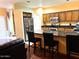 Open-concept kitchen featuring wood cabinets, dark countertops, stainless steel appliances, and an island with bar seating at 1750 W Union Hills Dr # 91, Phoenix, AZ 85027