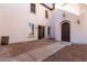 Private backyard featuring a concrete paver patio, access doors, and gravel ground cover at 18268 W Carol Ave, Waddell, AZ 85355