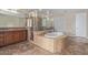 Luxurious bathroom featuring a glass enclosed shower and separate soaking tub at 18268 W Carol Ave, Waddell, AZ 85355