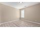 Cozy bedroom featuring modern flooring, neutral walls, and a window for natural light at 18268 W Carol Ave, Waddell, AZ 85355