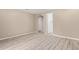 Bedroom with modern light wood floors and view of a closet and doorway at 18268 W Carol Ave, Waddell, AZ 85355