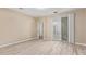 Bedroom with modern light wood floors and sliding glass doors with shades at 18268 W Carol Ave, Waddell, AZ 85355