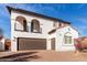 Charming two-story home with balconies, desert landscaping, and a brown two-car garage at 18268 W Carol Ave, Waddell, AZ 85355