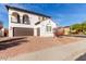 Charming two-story home with balconies, desert landscaping, and a brown two-car garage at 18268 W Carol Ave, Waddell, AZ 85355