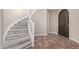 Foyer featuring a curved staircase, light grey hardwood steps, tile flooring, and wood door at 18268 W Carol Ave, Waddell, AZ 85355