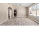 Bright living room featuring new floors, large windows, and arched doorway at 18268 W Carol Ave, Waddell, AZ 85355