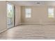 Bright living room featuring wood flooring and a sliding door leading to a patio at 18268 W Carol Ave, Waddell, AZ 85355