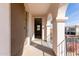 Covered patio space with view through sliding door to interior of house at 18268 W Carol Ave, Waddell, AZ 85355