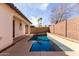 Backyard pool area, framed by desert landscaping and a block wall for privacy at 18268 W Carol Ave, Waddell, AZ 85355