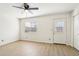 Bright, airy bedroom with wood-look flooring, lots of natural light, and a door for easy outdoor access at 2117 W Pontiac Dr, Phoenix, AZ 85027