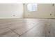 A ground-level shot of an empty bedroom with vinyl floors and natural light from window at 2117 W Pontiac Dr, Phoenix, AZ 85027