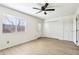 Bright bedroom with a ceiling fan, wood-look flooring, lots of natural light, and a spacious closet at 2117 W Pontiac Dr, Phoenix, AZ 85027