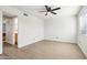 Bright, vacant bedroom with light wood laminate flooring and a ceiling fan at 2117 W Pontiac Dr, Phoenix, AZ 85027