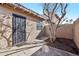 Exterior shot of the house featuring a metal security door, xeriscaping, and mature tree at 2117 W Pontiac Dr, Phoenix, AZ 85027