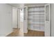 Hallway with open door to bedroom and closet with folding doors and decorative glass shelving at 2117 W Pontiac Dr, Phoenix, AZ 85027