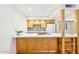 Kitchenette with white countertop, updated tile backsplash and stainless steel appliances at 2117 W Pontiac Dr, Phoenix, AZ 85027