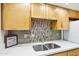 Close-up of kitchen sink with stylish tile backsplash, stainless steel faucet and undermount sink at 2117 W Pontiac Dr, Phoenix, AZ 85027