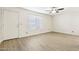 Bright, empty living area with wood-look flooring, a ceiling fan, and natural light from a window at 2117 W Pontiac Dr, Phoenix, AZ 85027