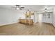 Open-concept living area with wood-look flooring, seamlessly connected to the kitchen, bathed in natural light at 2117 W Pontiac Dr, Phoenix, AZ 85027