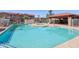 Community swimming pool and hot tub with covered seating area and a surrounding fence at 2117 W Pontiac Dr, Phoenix, AZ 85027