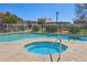 Community pool featuring a spa, metal fence and manicured landscaping for relaxation and enjoyment at 2117 W Pontiac Dr, Phoenix, AZ 85027