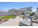 Landscaped backyard with travertine tile, artificial turf, and an outdoor kitchen at 21186 W Hillcrest Blvd, Buckeye, AZ 85396