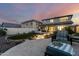 A spacious backyard with seating, patio, artificial turf, desert landscaping and evening sky at 21186 W Hillcrest Blvd, Buckeye, AZ 85396