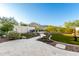 Landscaped backyard featuring a paver patio, artificial turf, and mountain views at 21186 W Hillcrest Blvd, Buckeye, AZ 85396