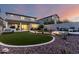 Open backyard features a covered patio, outdoor kitchen, artificial turf and desert landscaping at 21186 W Hillcrest Blvd, Buckeye, AZ 85396