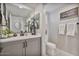 Cozy bathroom features a gray vanity, framed mirror, and a patterned floor tiling at 21186 W Hillcrest Blvd, Buckeye, AZ 85396