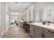 Bright bathroom with double vanity, vanity table, modern mirrors and lighting, and wood-look tile flooring at 21186 W Hillcrest Blvd, Buckeye, AZ 85396