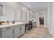 Bathroom features dual sinks, gray cabinets, mirrors, and modern fixtures at 21186 W Hillcrest Blvd, Buckeye, AZ 85396