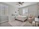 Bedroom featuring neutral walls, wood ceiling fan, light colored furniture, and a decorative rug at 21186 W Hillcrest Blvd, Buckeye, AZ 85396