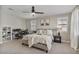 Bedroom with a ceiling fan, plantation shutters, and a dedicated workstation at 21186 W Hillcrest Blvd, Buckeye, AZ 85396