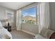 Bedroom offering mountain views from the large window with light drapes and shutters at 21186 W Hillcrest Blvd, Buckeye, AZ 85396