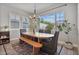 Inviting dining room with large windows, a modern chandelier, and a stylish rug creating a warm ambiance at 21186 W Hillcrest Blvd, Buckeye, AZ 85396