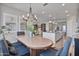 This dining area showcases a blend of modern lighting and an open layout adjacent to the kitchen and living room at 21186 W Hillcrest Blvd, Buckeye, AZ 85396