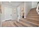 Inviting foyer with wood-look flooring, staircase, and an elegant front door at 21186 W Hillcrest Blvd, Buckeye, AZ 85396